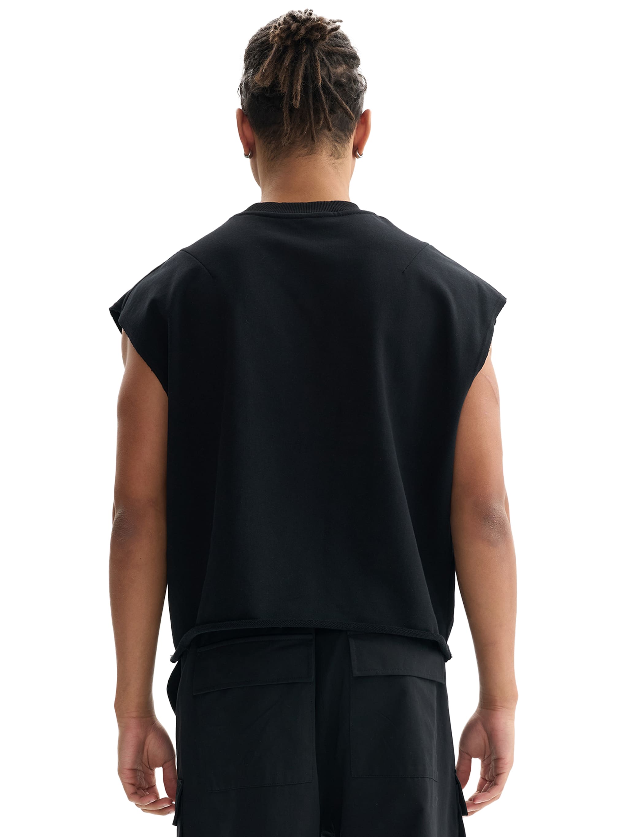 Back view of man wearing black french terry boxy tank top with relaxed fit and sleeveless design