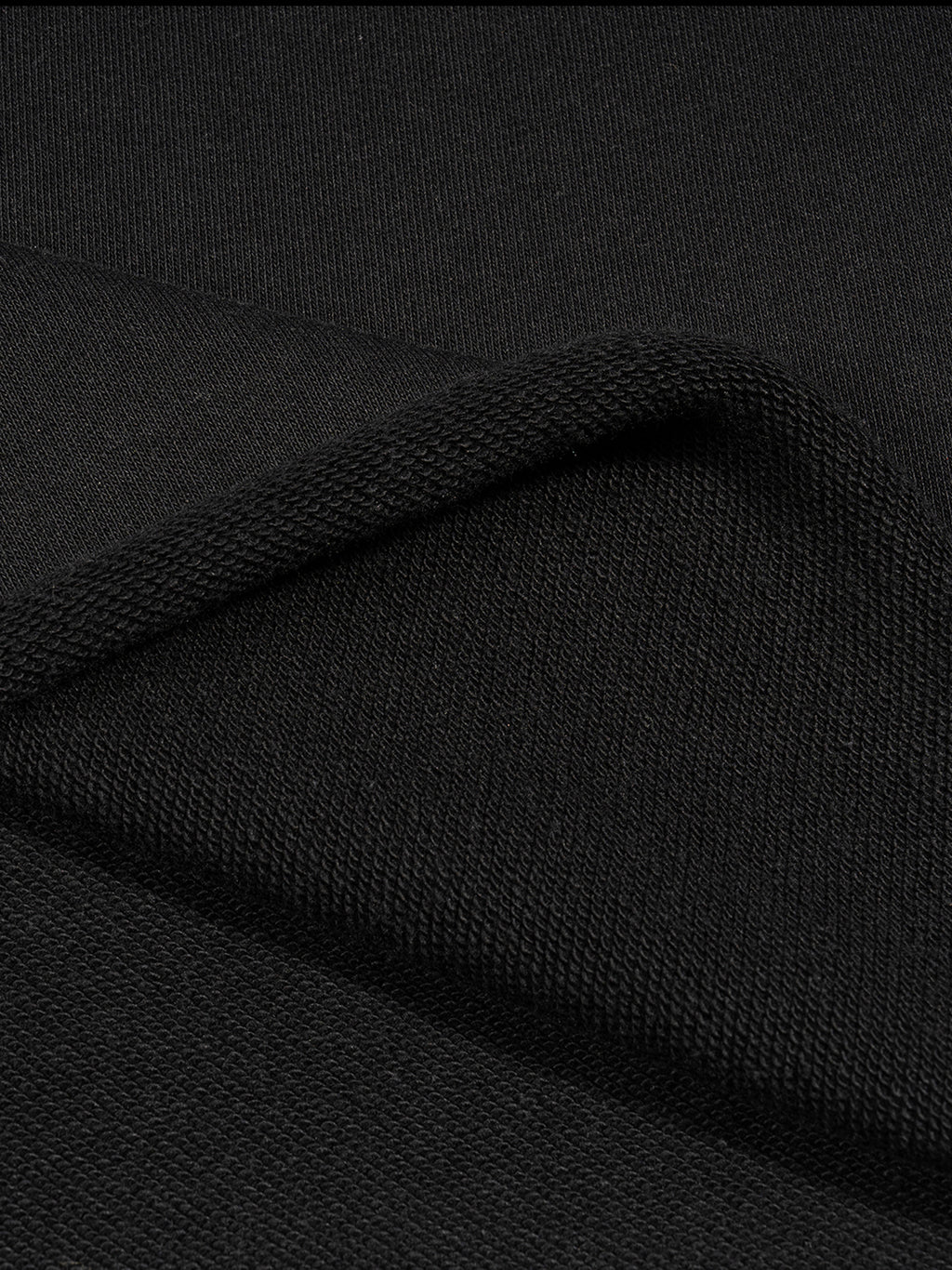 Close-up texture of black fabric used in FETISHISTO french terry boxy tank top showing soft knit detail