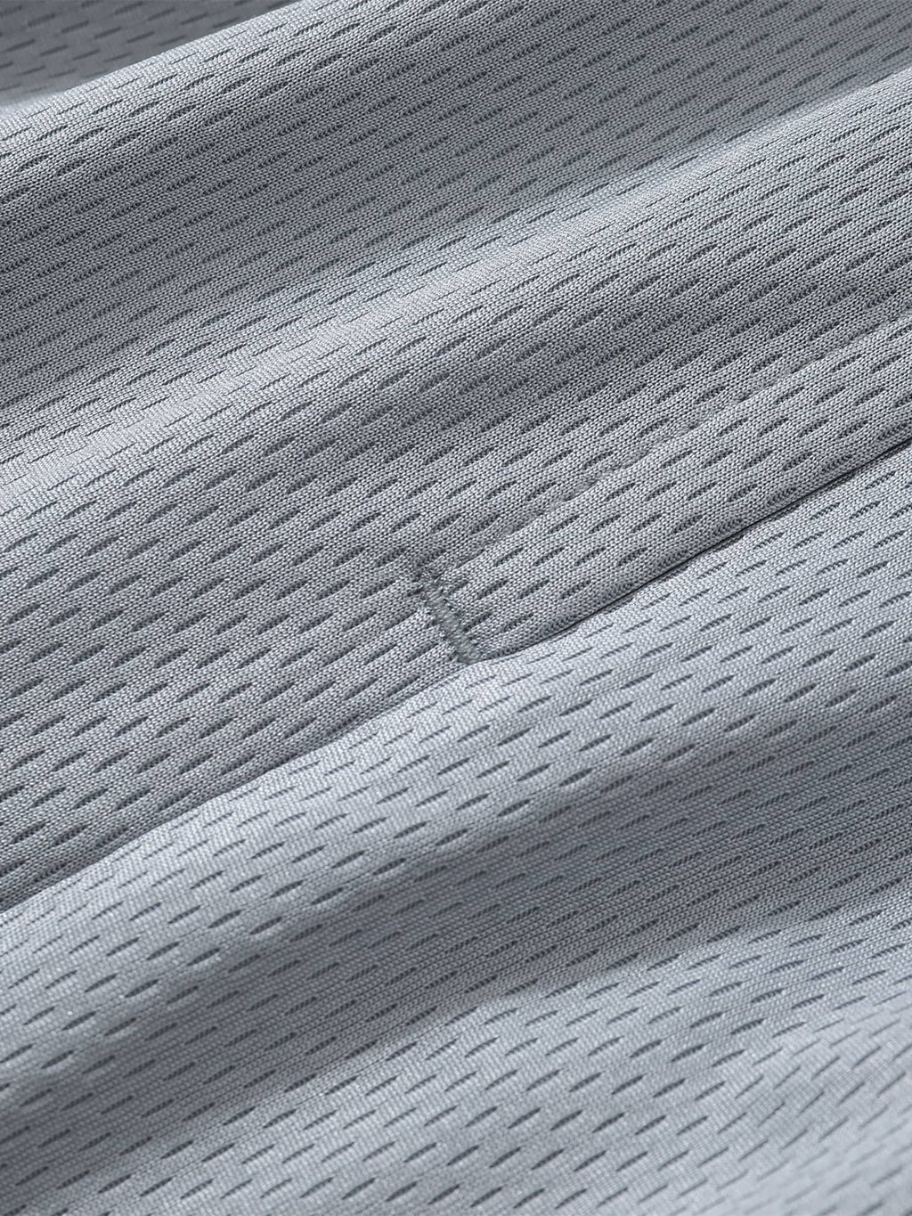 Close-up of breathable mesh fabric texture used in classic basketball shorts by FETISHISTO