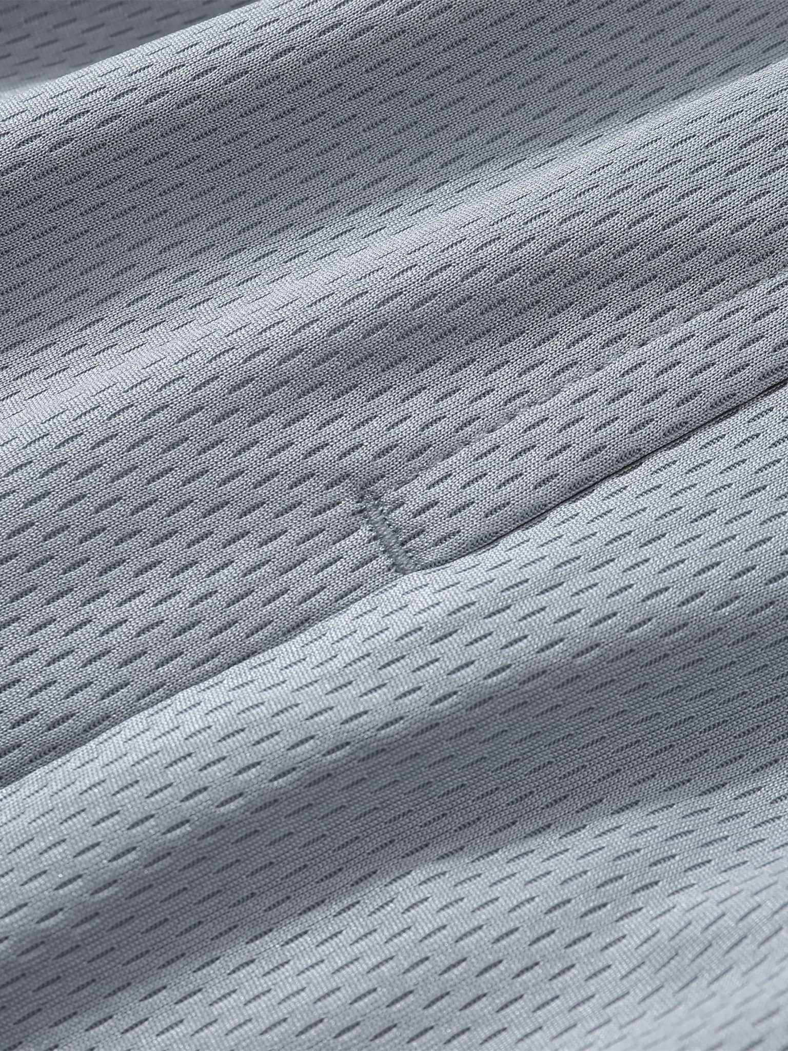 Close-up of breathable mesh fabric texture used in classic basketball shorts by FETISHISTO