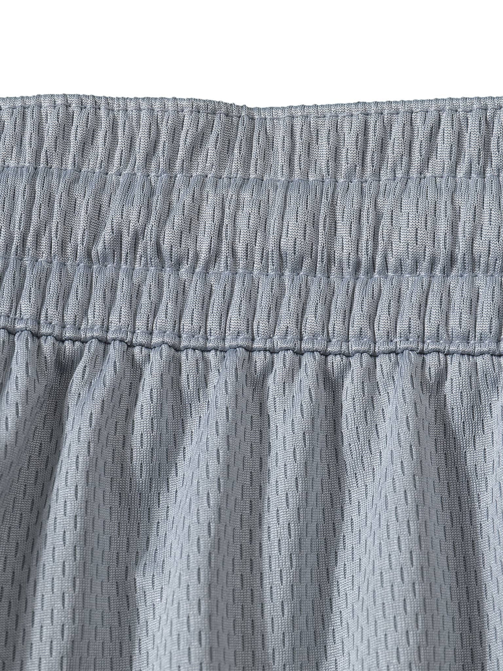 Close-up of grey mesh fabric waistband showing detailed stitching on classic basketball shorts