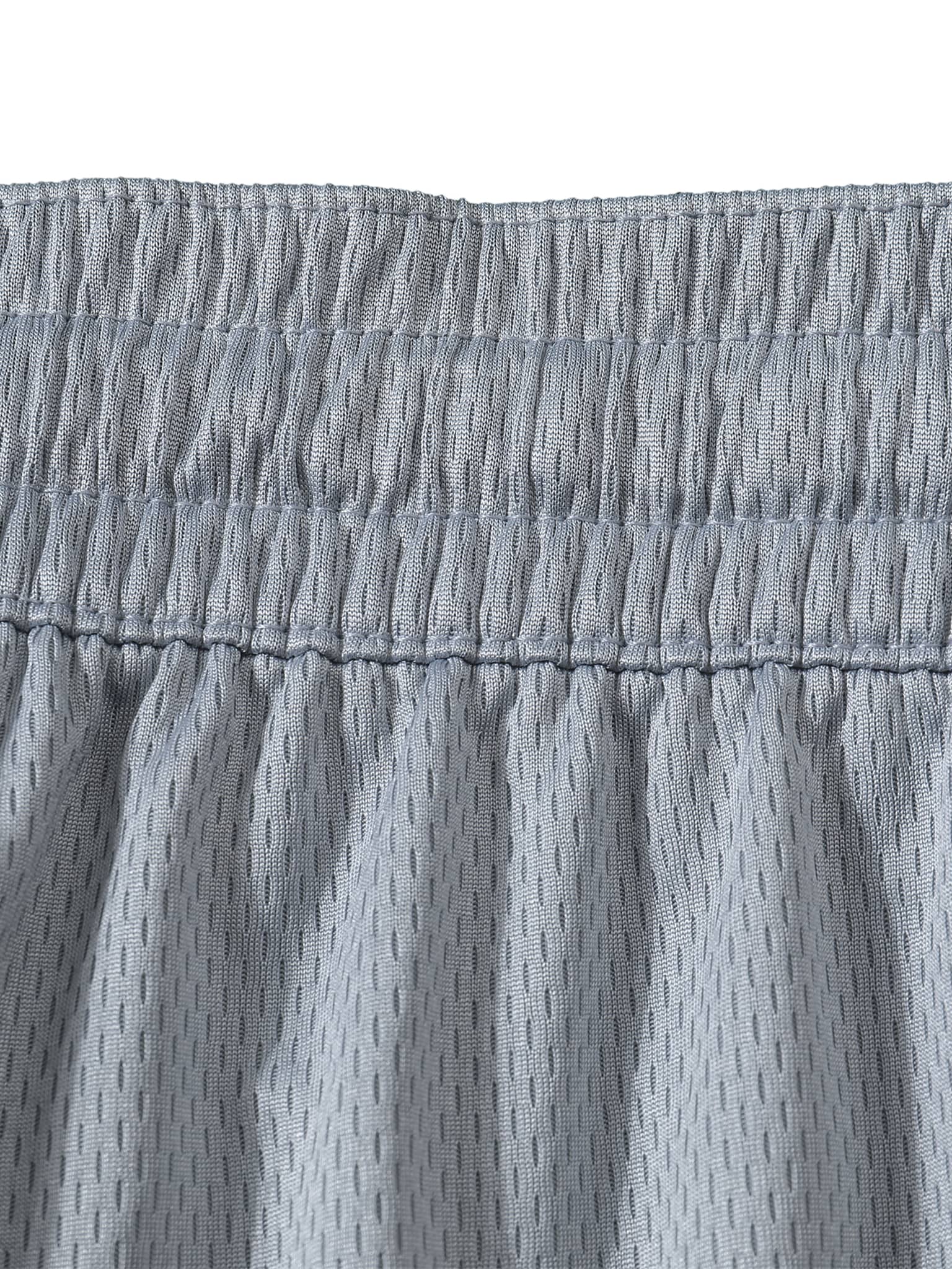 Close-up of grey mesh fabric waistband showing detailed stitching on classic basketball shorts