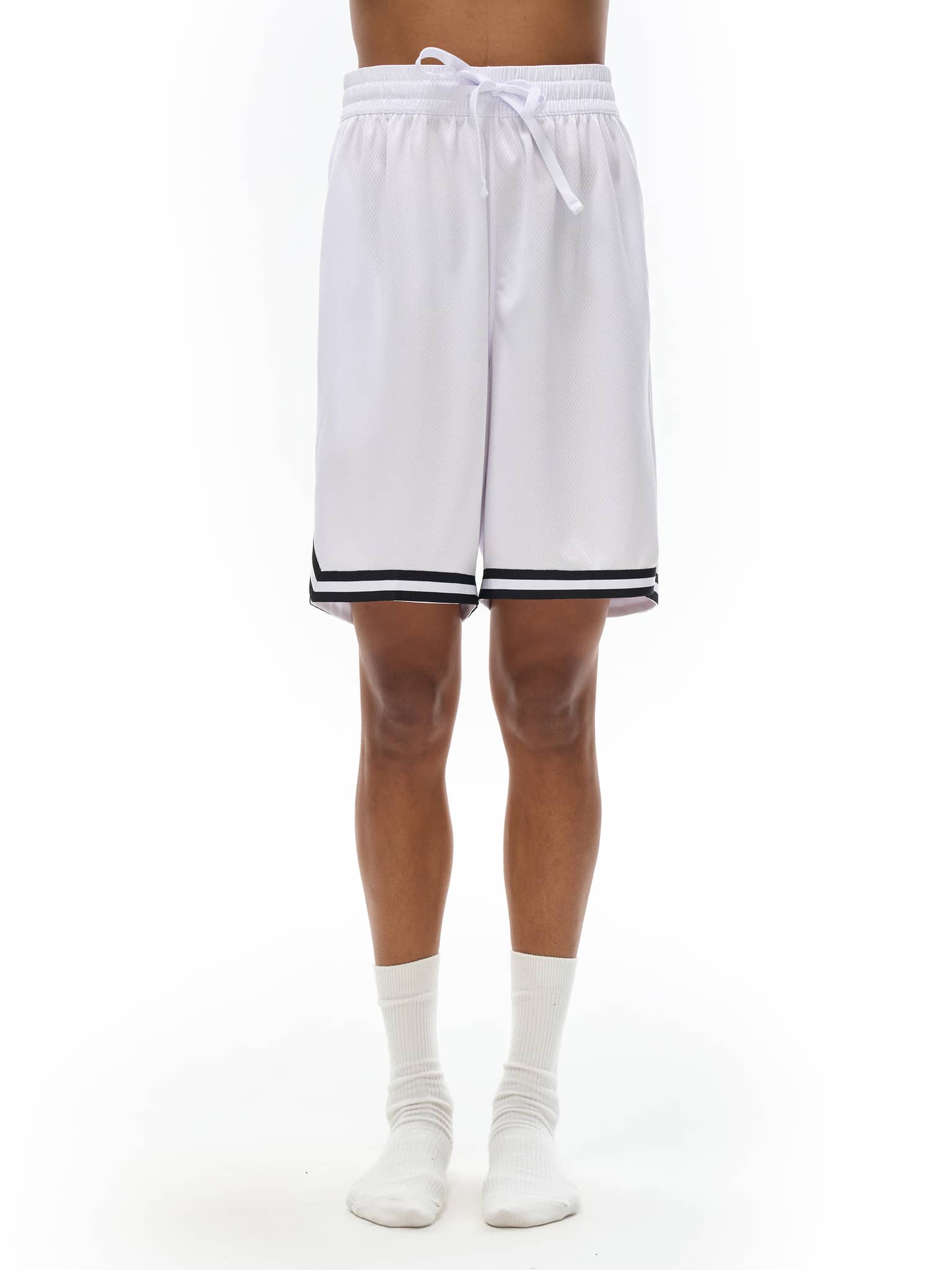 White FETISHISTO classic basketball shorts with black trim worn by model standing on white background