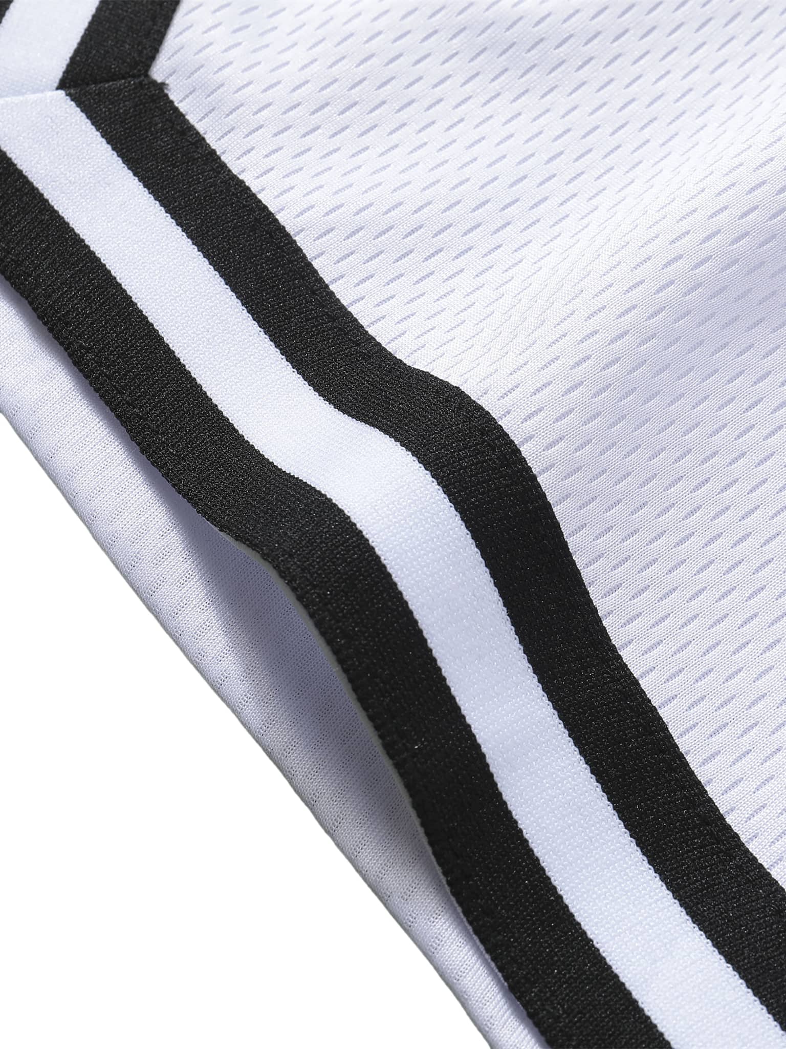 Close-up of FETISHISTO classic basketball shorts white fabric with black and white striped trim