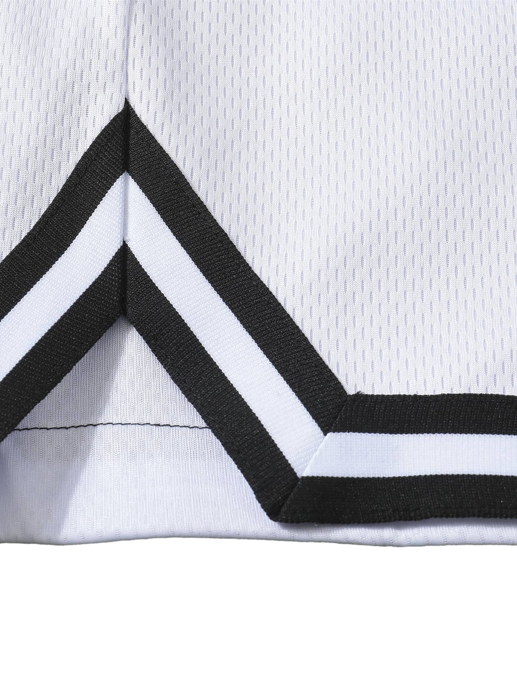 Close-up of white classic basketball shorts with black and white striped trim detailing