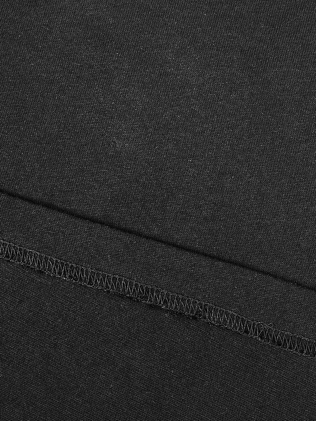 Close-up of black fabric stitching detail on contrast piped fetish t-shirt by FETISHISTO