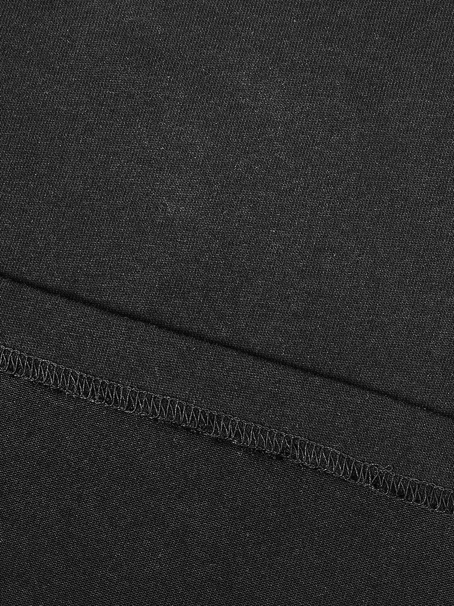 Close-up of black fabric stitching detail on contrast piped fetish t-shirt by FETISHISTO