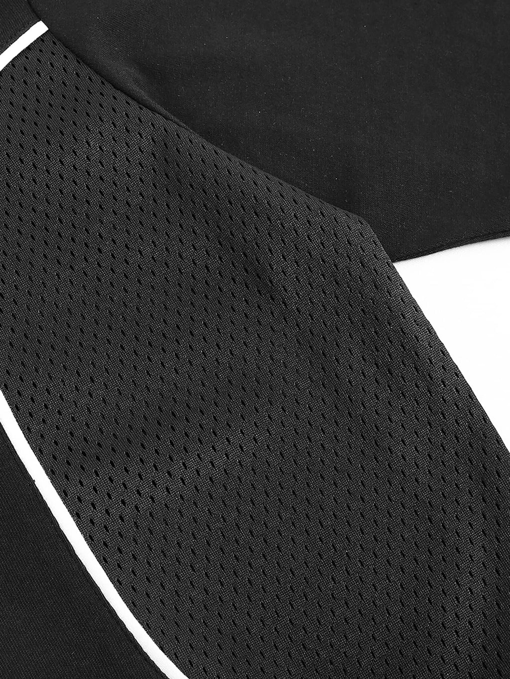 Close-up of black contrast piped fetish t-shirt featuring mesh fabric and white piping detail