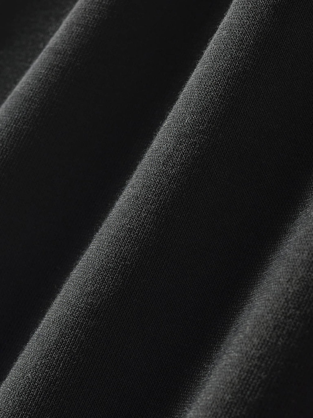 Close-up texture detail of black fabric for contrast side-stripe straight-leg pants