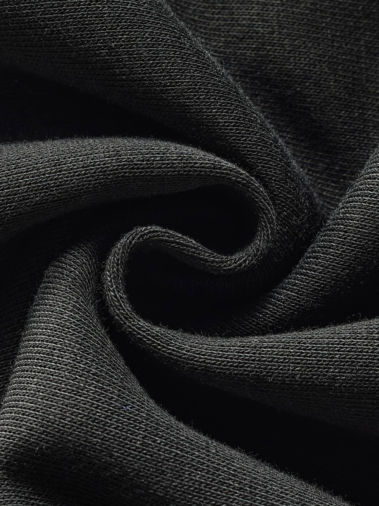 Close-up of black fabric material used in contrast side-stripe straight-leg pants by FETISHISTO