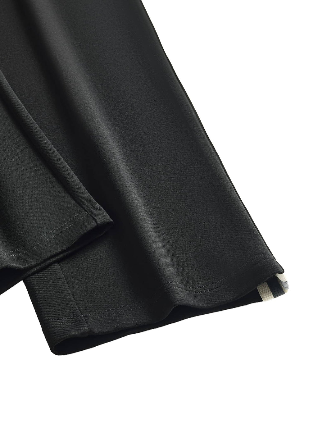 Close-up of FETISHISTO contrast side-stripe straight-leg pants showing black fabric with white side stripe detail