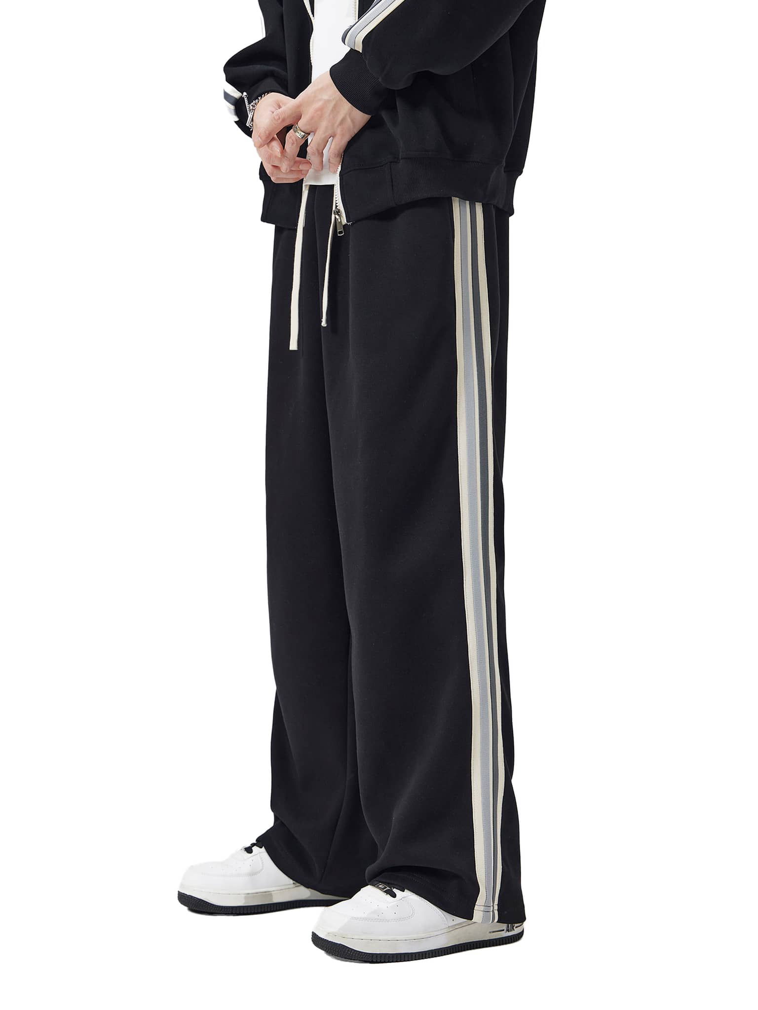 FETISHISTO black contrast side-stripe straight-leg pants with white and gray stripes worn with white sneakers