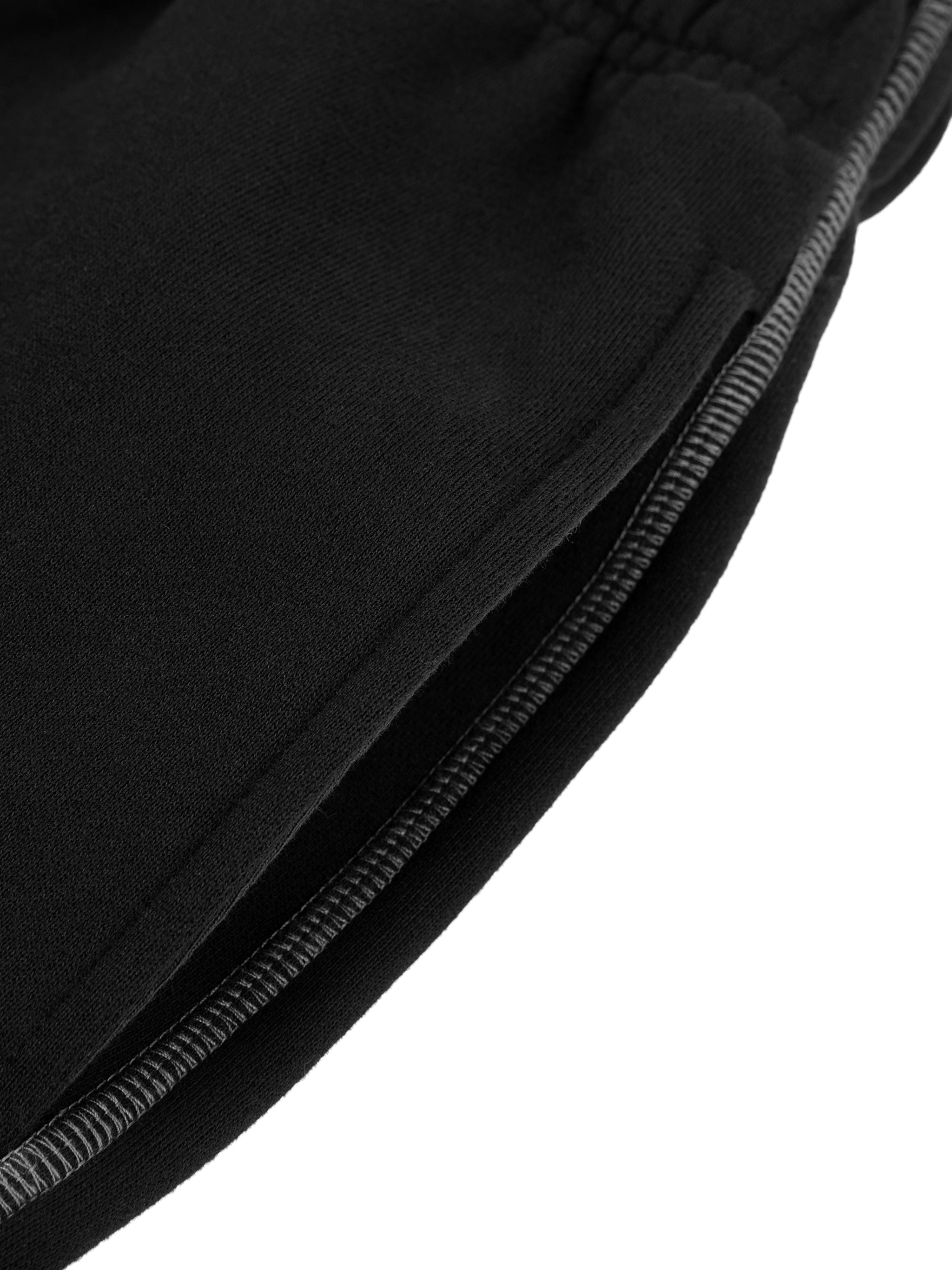 Close-up of black contrast stitch fleece sweatpants showing detailed stitching and pocket