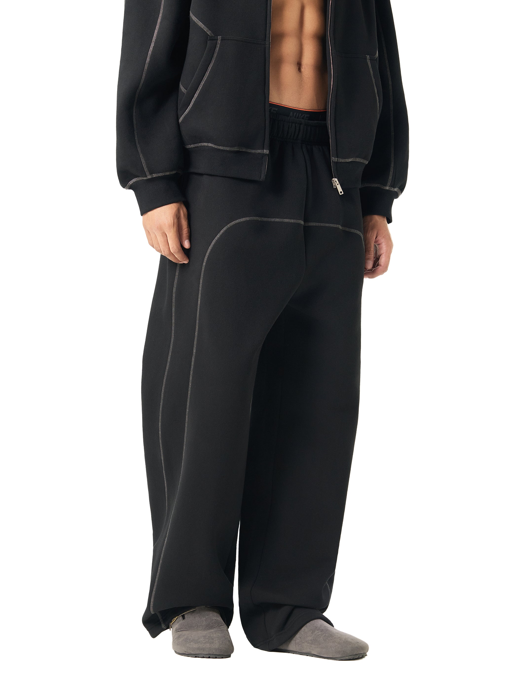 Black contrast stitch fleece sweatpants with wide legs and elastic waist by FETISHISTO