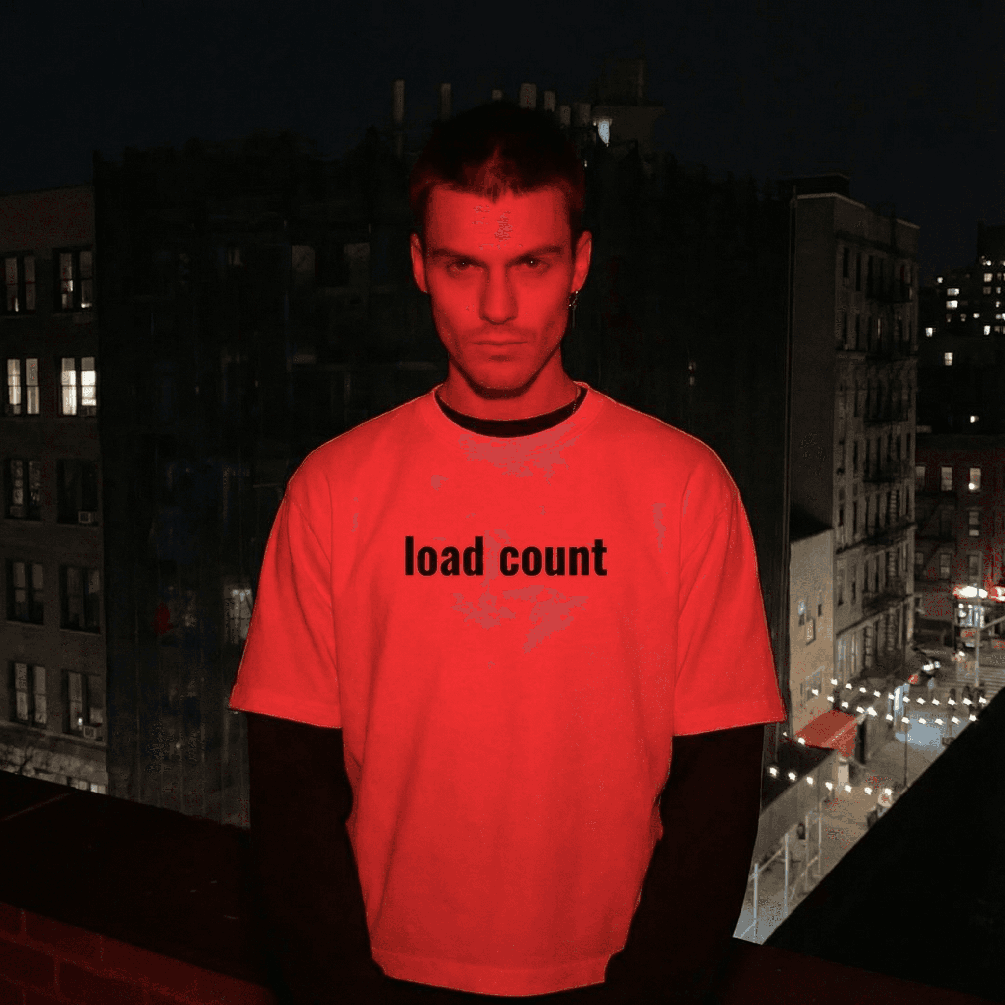 FETISHISTO layered contrast sleeve t-shirt with load count text worn by model at night city rooftop