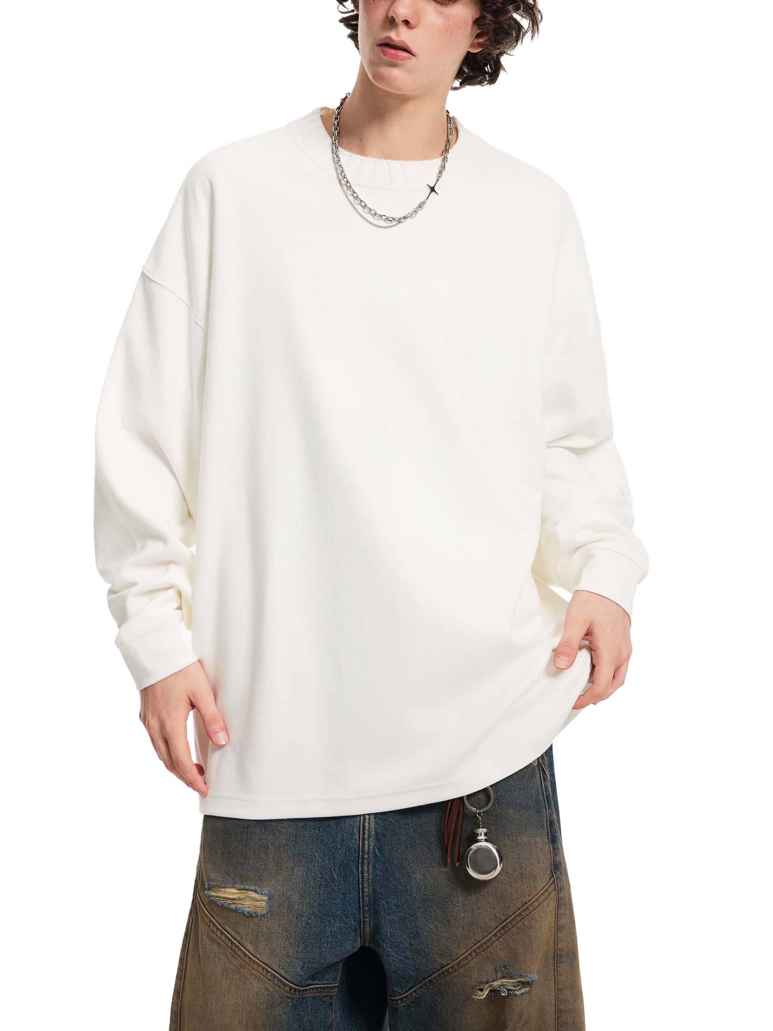 FETISHISTO oversize knitted round neck sweatshirt in white worn by model with distressed jeans