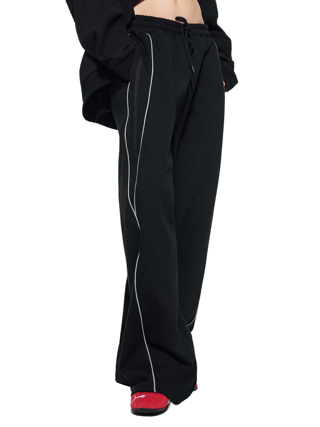 Black reflection striped sweatpants with white side stripes and drawstring waist from FETISHISTO