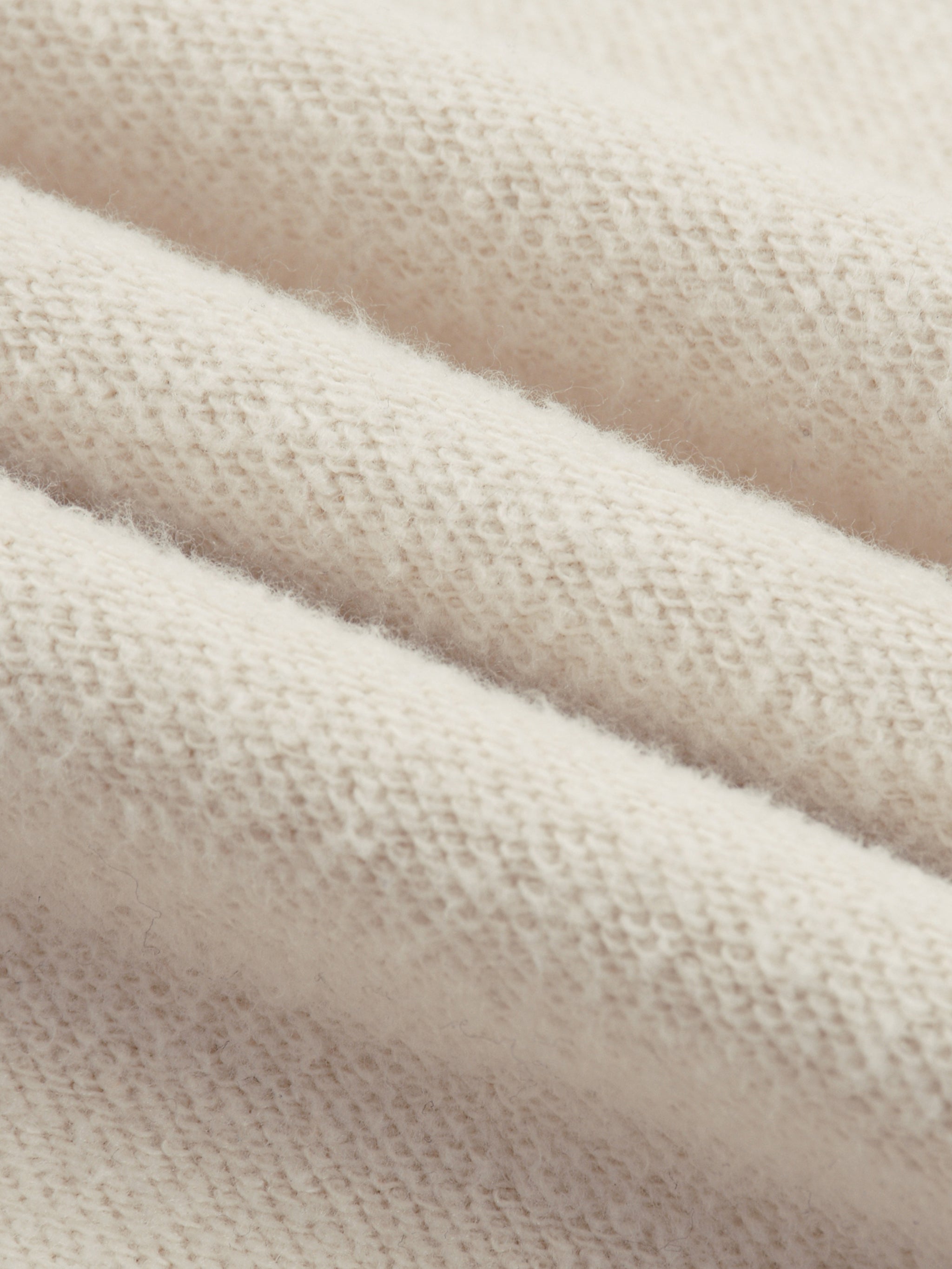 Close-up texture of soft fabric for reflection striped sweatpants by FETISHISTO in light beige color