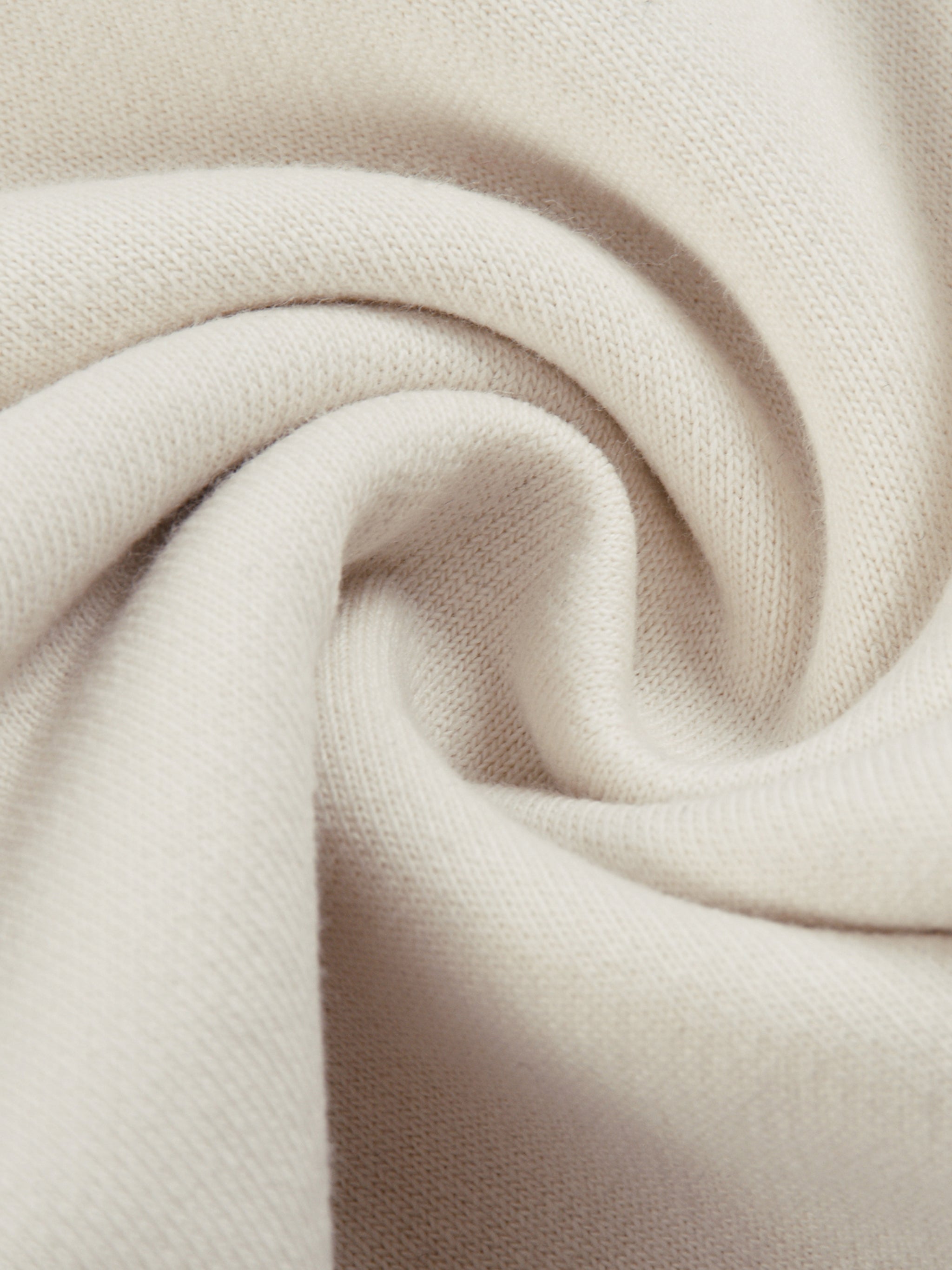 Close-up of soft beige fabric texture for FETISHISTO reflection striped sweatpants