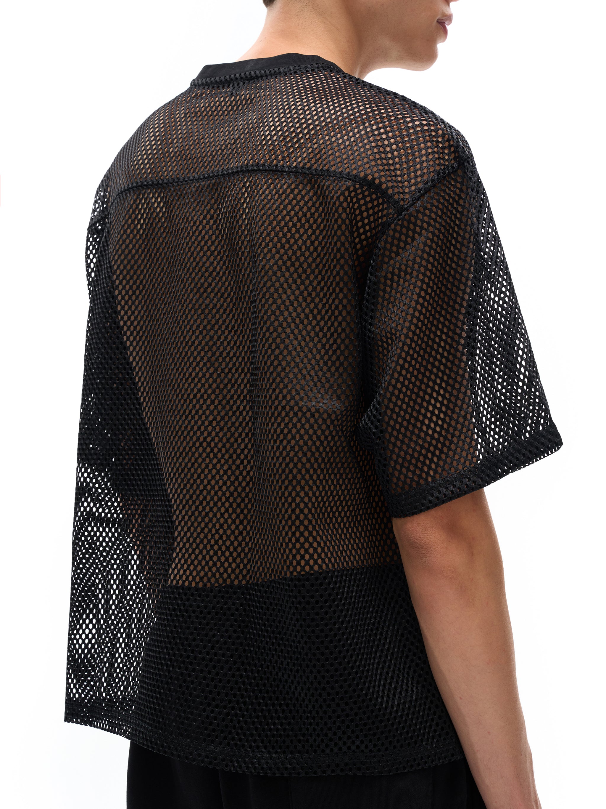 Black see-through mesh t-shirt by ODMPOD worn by a male model showing back and side view