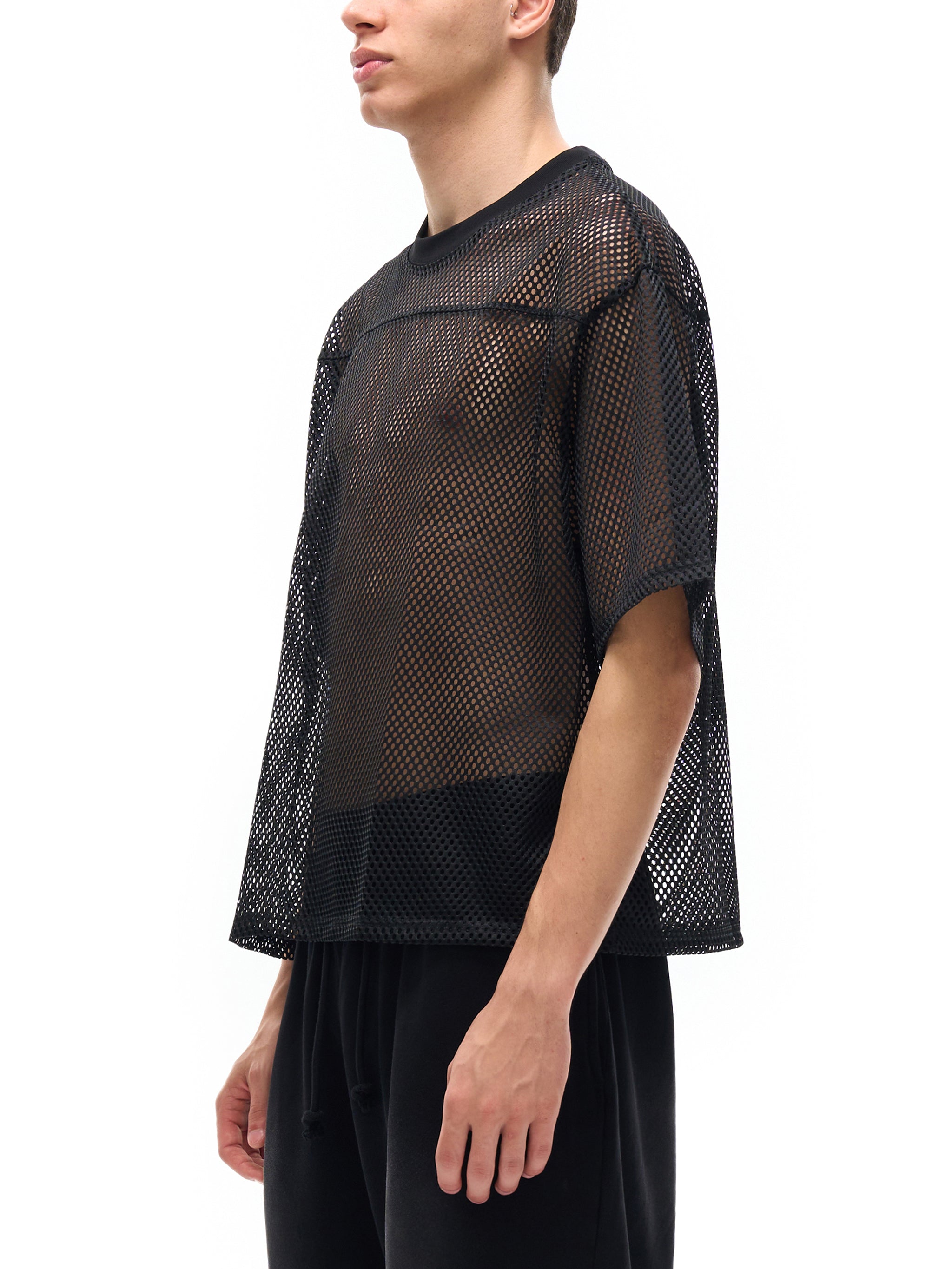 ODMPOD black see-through mesh t-shirt worn by male model with loose fit and short sleeves