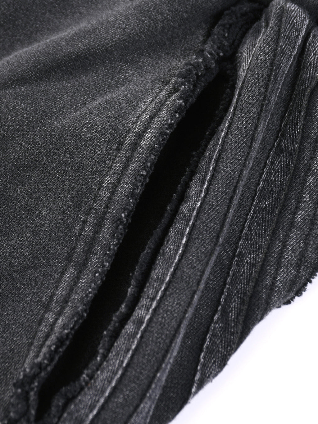 Close-up detail of black snow washed sweatpants for men showing fabric texture and stitching by FETISHISTO