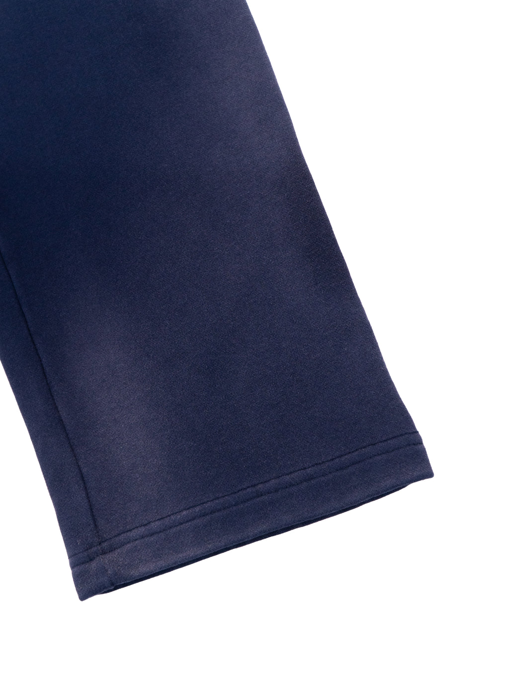 Close-up of navy sun fade straight leg sweatpants hem by FETISHISTO showing fabric texture and stitching