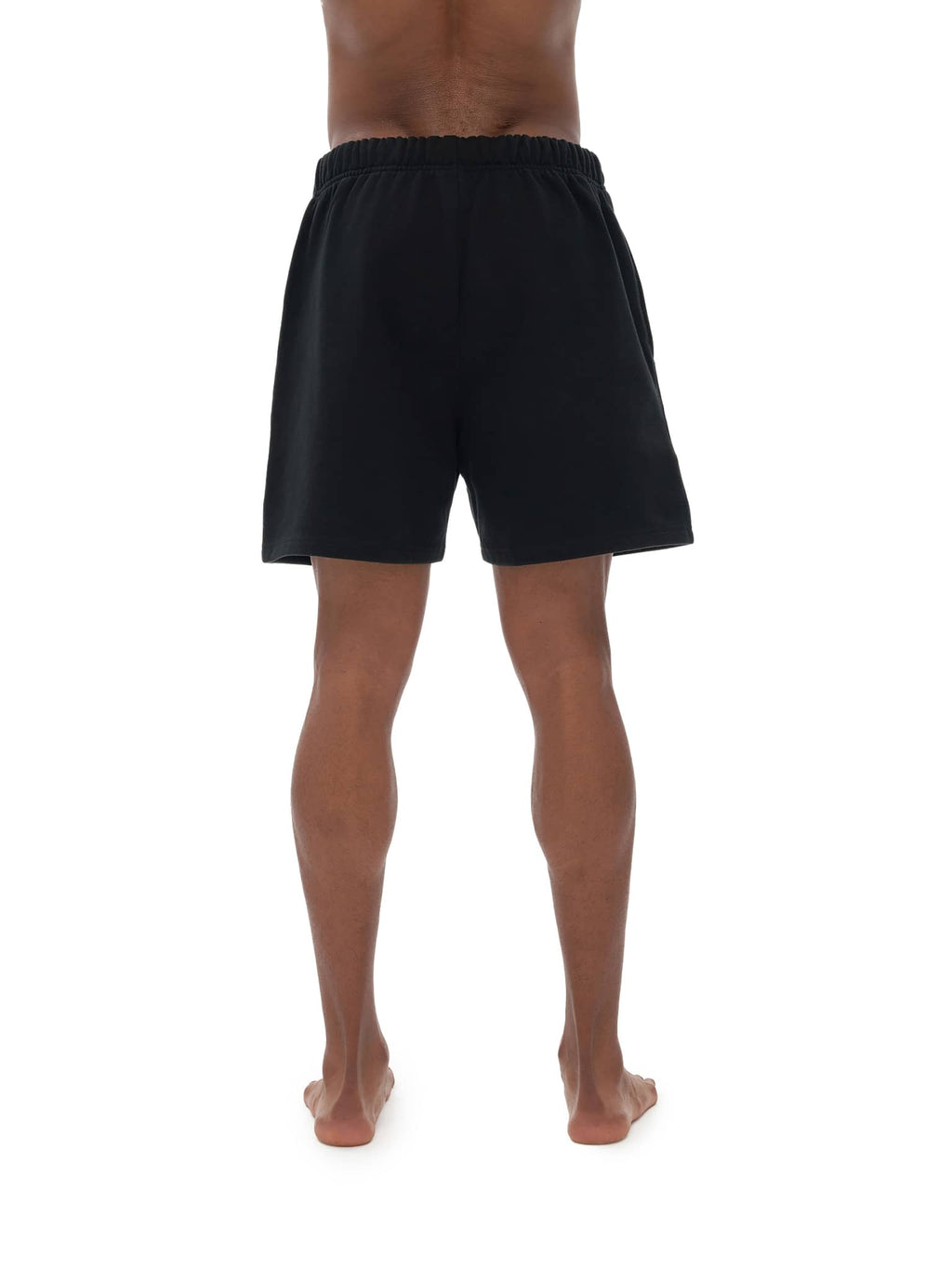Rear view of person wearing black unisex heavyweight fleece shorts by FETISHISTO