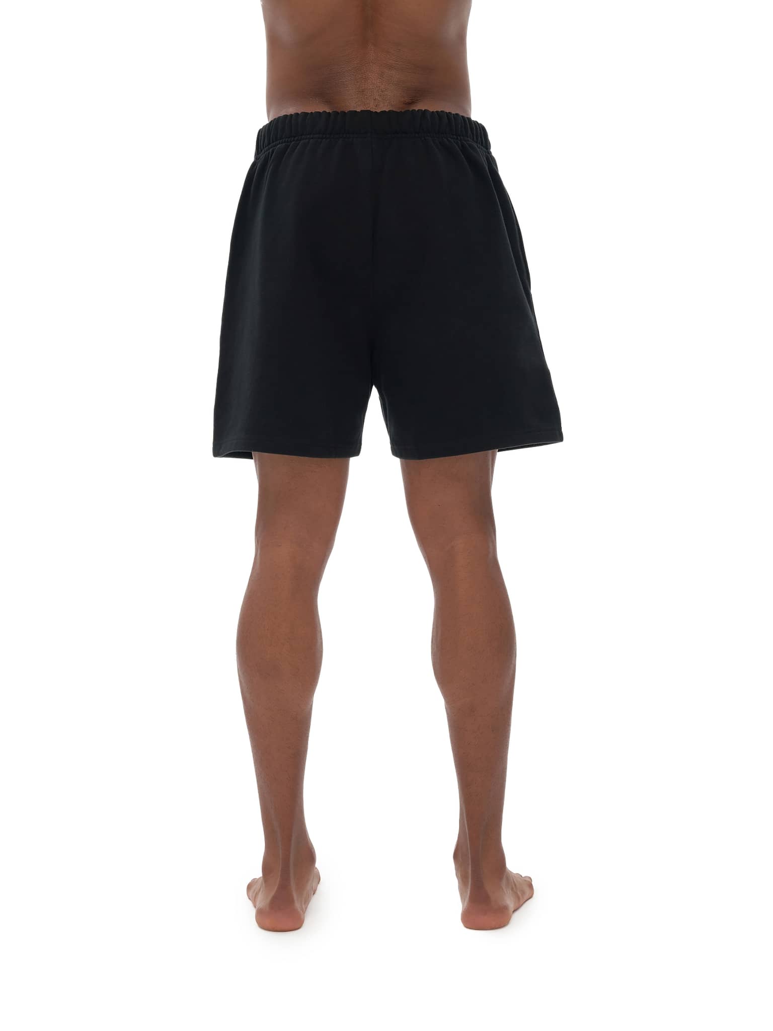 Rear view of person wearing black unisex heavyweight fleece shorts by FETISHISTO
