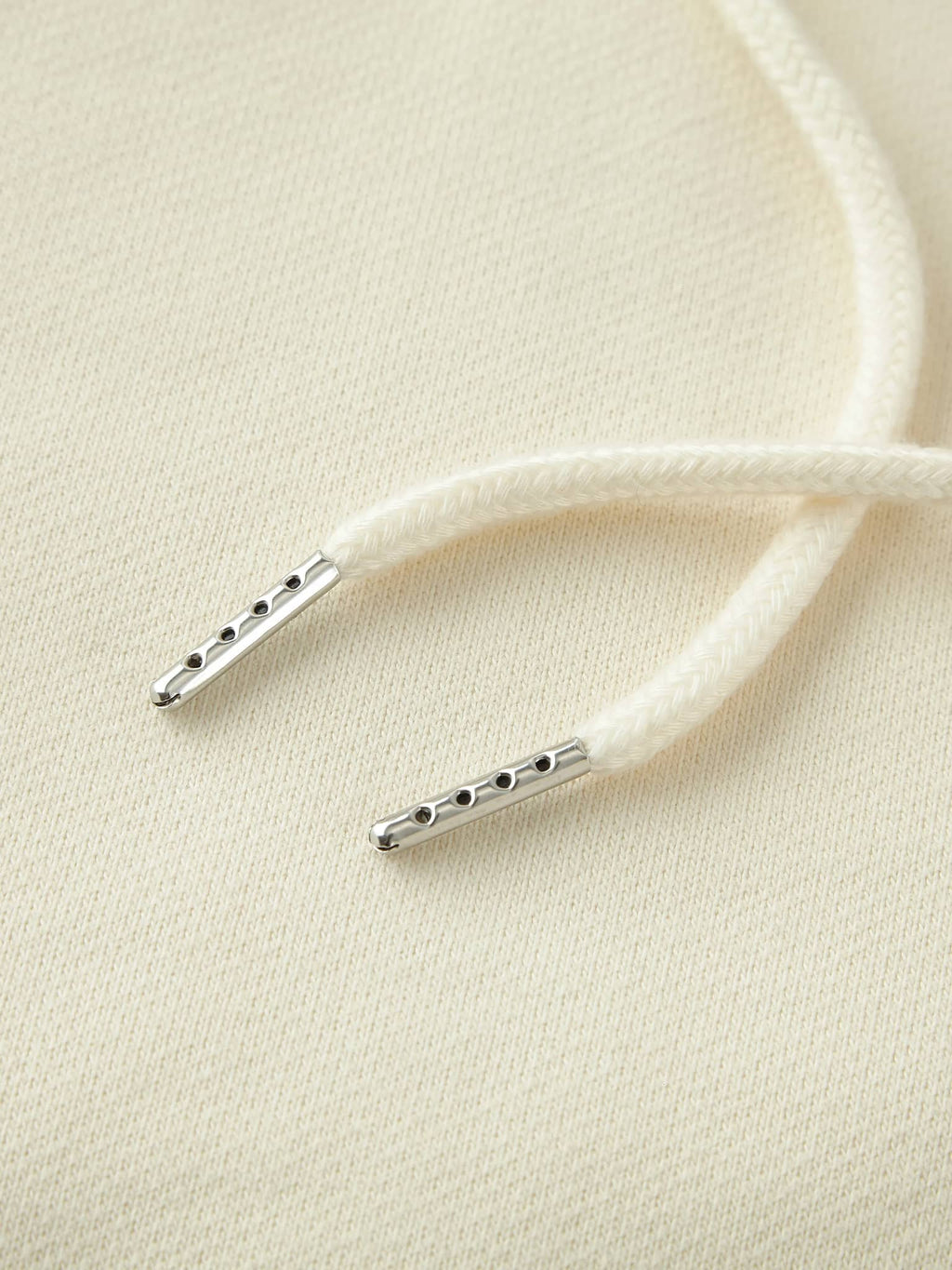 Close-up of white drawstring with metal tips on unisex heavyweight fleece shorts by FETISHISTO