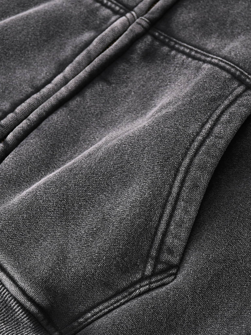 Close-up of black fabric and stitching detail on zip through boxy fleece hoodie by FETISHISTO
