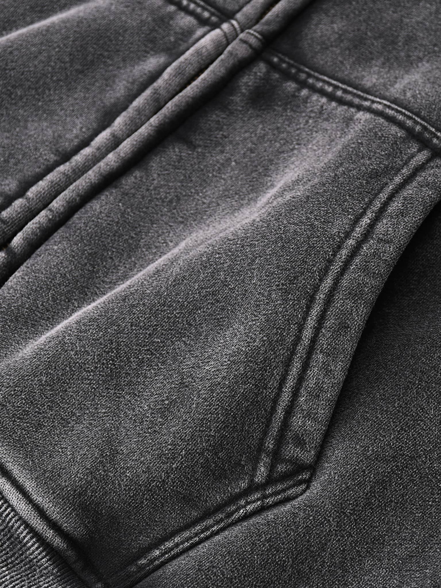 Close-up of black fabric and stitching detail on zip through boxy fleece hoodie by FETISHISTO