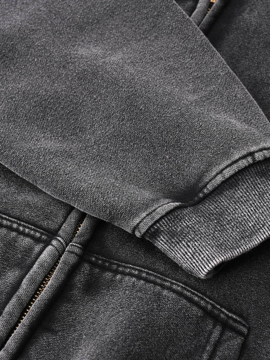 Close-up of black zip through boxy fleece hoodie sleeve and pocket details by FETISHISTO