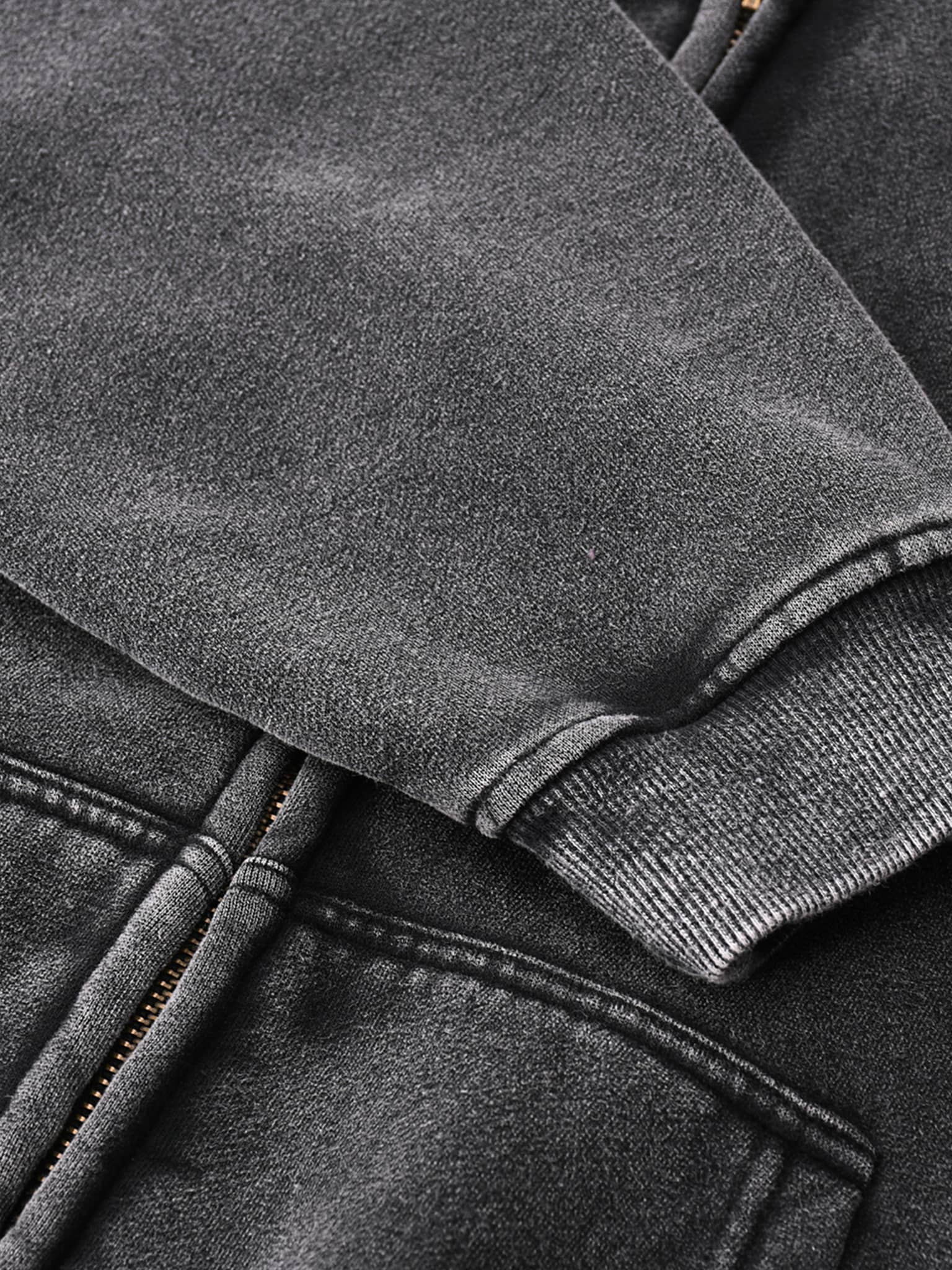 Close-up of black zip through boxy fleece hoodie sleeve and pocket details by FETISHISTO